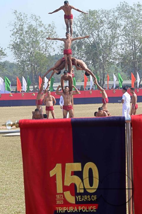 Police officials perform Mallakhamb, a traditional sport, in celebration of 150 years of Tripura Police Week at the stadium of A.D