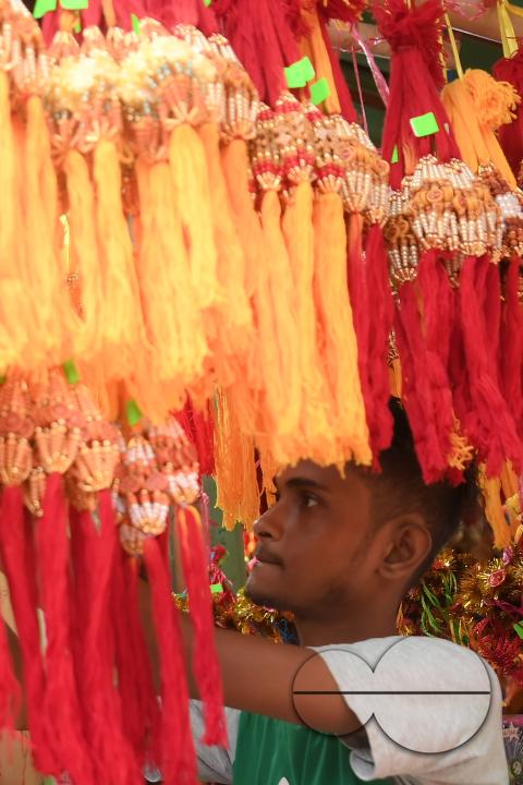 A shop owner arranging "Rakhi", sacred threads for the upcoming "Raksha Bandhan" festival at his shop in Agartala