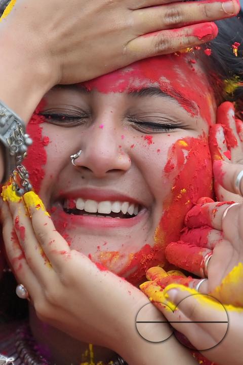 Indian girls adorned with 'Gulal' or coloured powder during the Hindu spring festival 'Holi', the festival of colour in Agartala