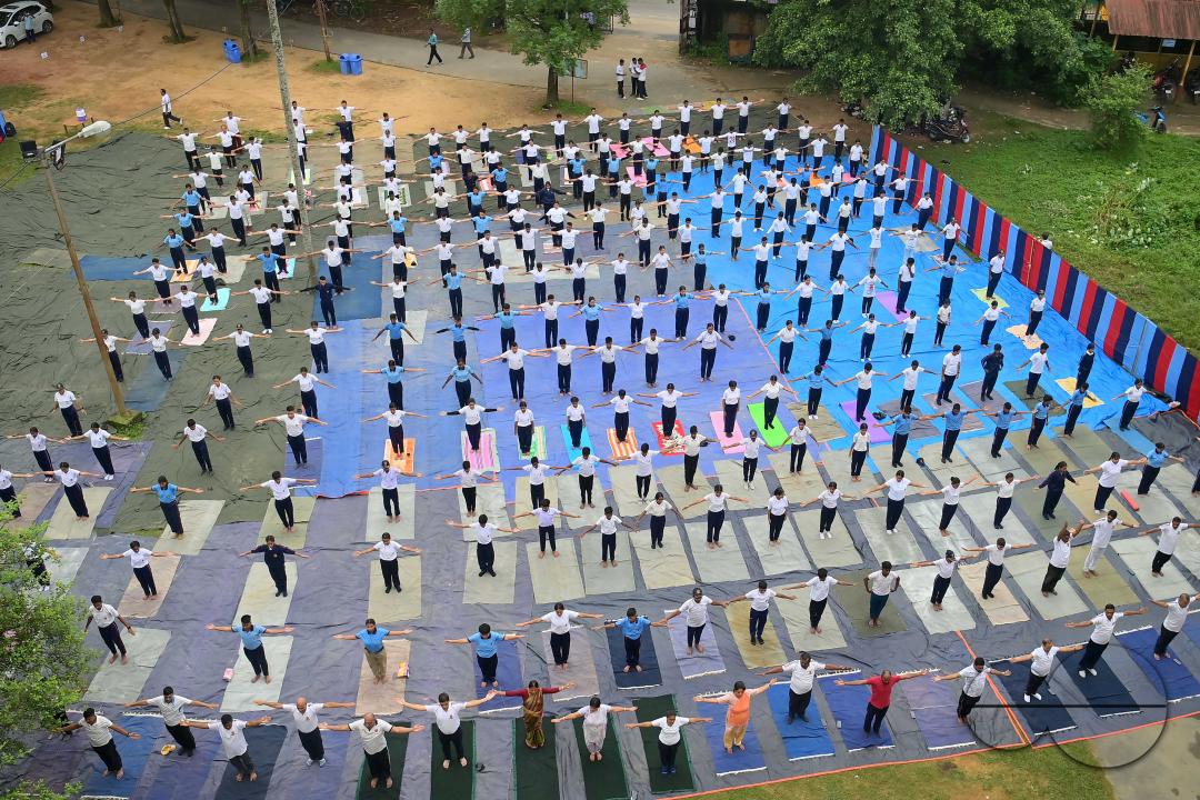 NCC cadets and officials perform yoga during 10th International Day of Yoga Day at BBM College Ground in Agartala