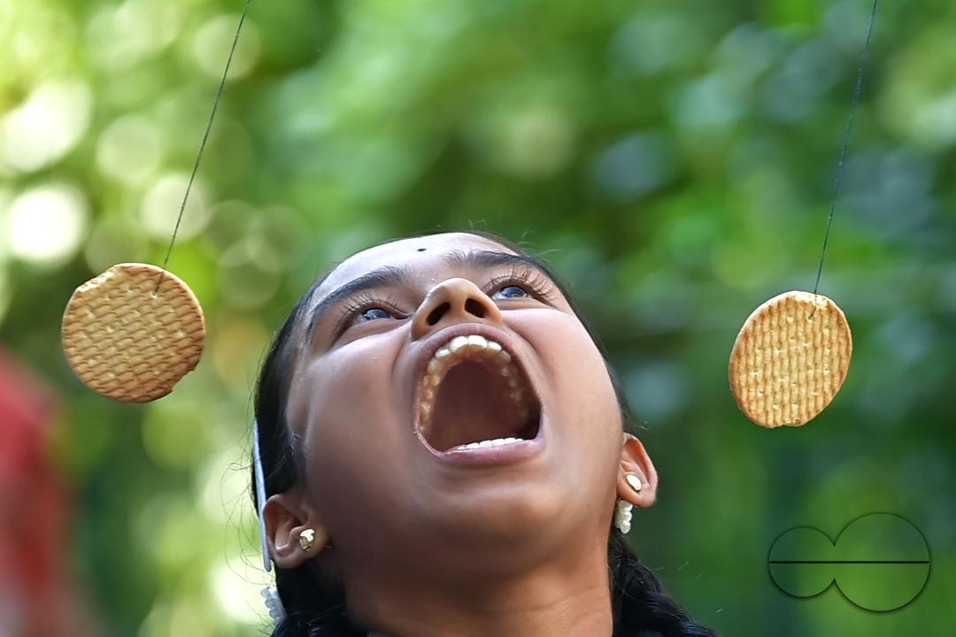 A student at the Institute for Visually Handicapped is participating in a 'Biscuit Race' during the 'Children's Day' celebration at the institute's campus in Narsingarh, in Agartala