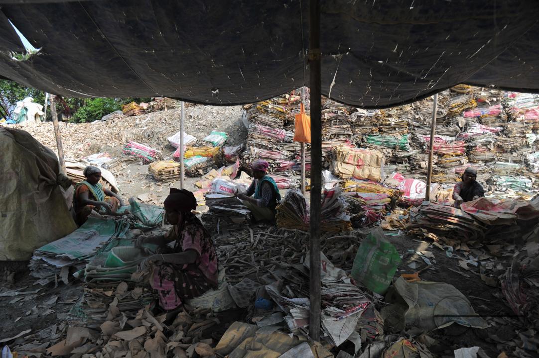 Women are risking their lives to wash cement bags beside the Surma River in Sylhet