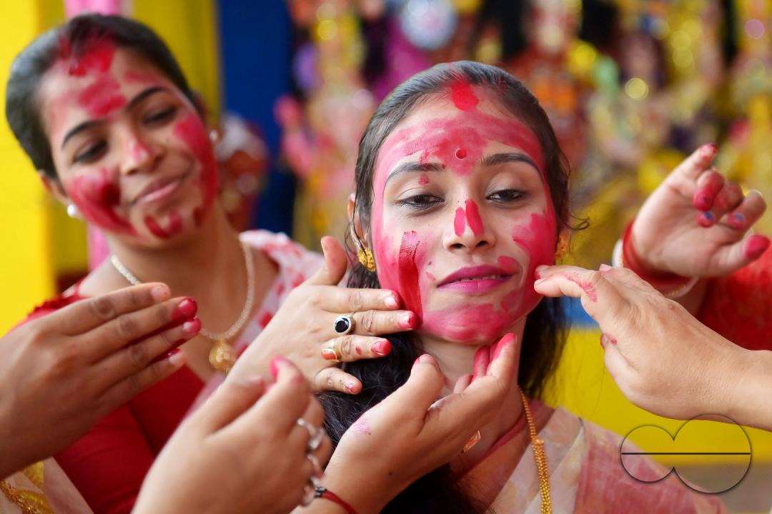 Married women smear each other with vermillion during a ritual called the vermillion game, or "Sindur Khela," on the last day of the Durga Puja festival in Agartala, Tripura, India.