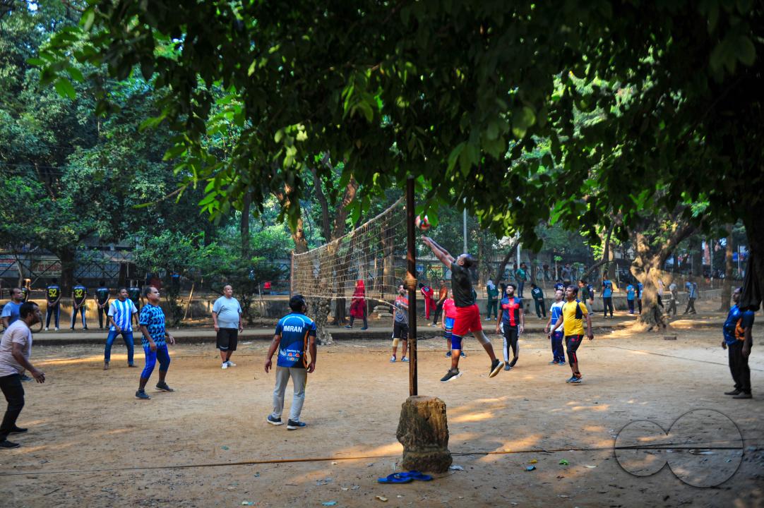 People playing volleyball in the Dhanmondi Lake