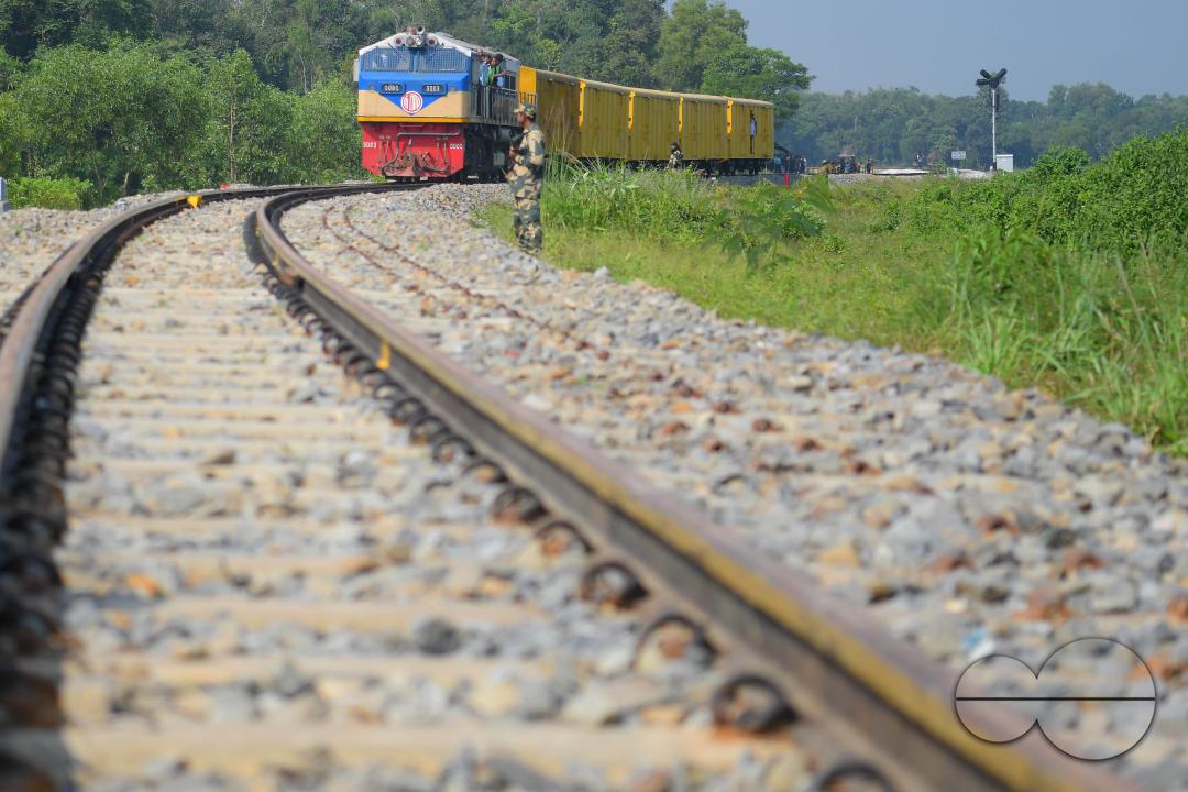 Indian people looking at a trial train and taking photographs, which is crossing the Indo-Bangladesh border