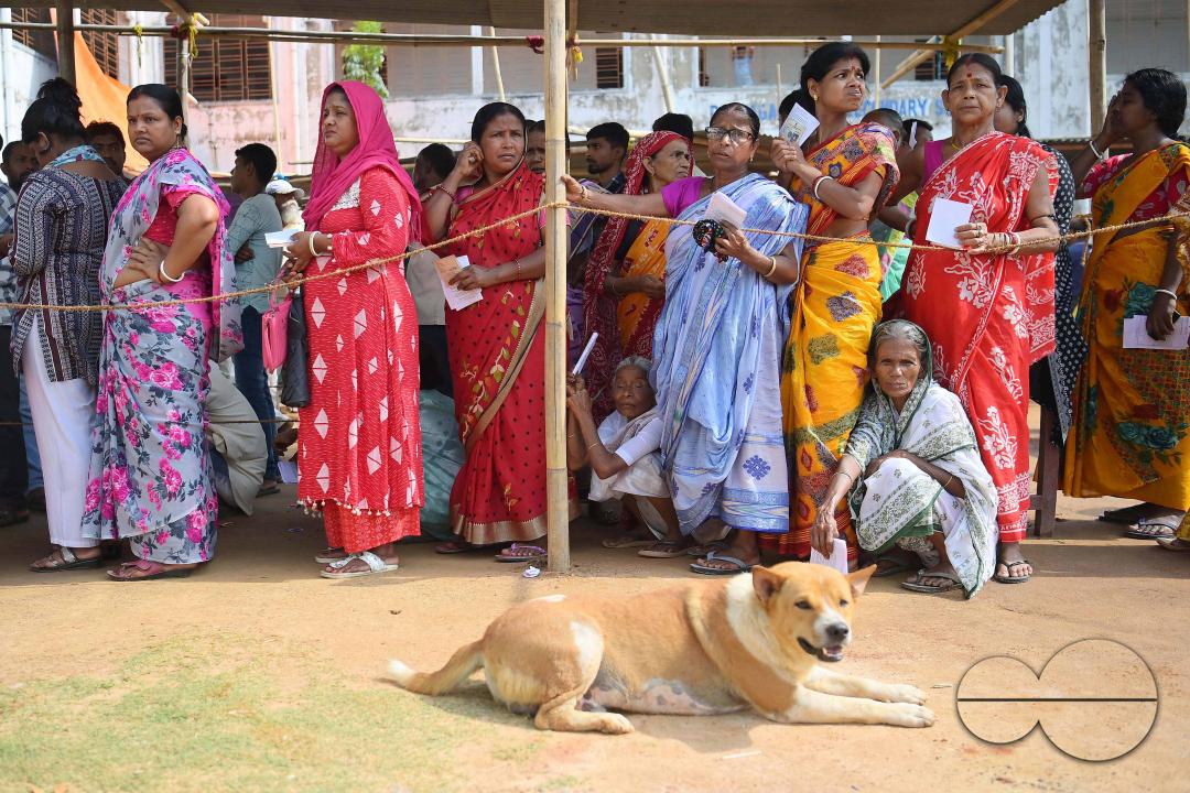 Elderly women line up to exercise their right to vote in the first phase of Lok Sabha elections at a polling station in Agartala