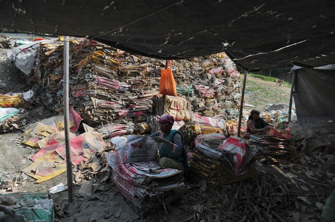 Sylhet-Bangladesh: Women Workers are risking their lives to wash cement bags beside of Surma river in Sylhet, Bangladesh