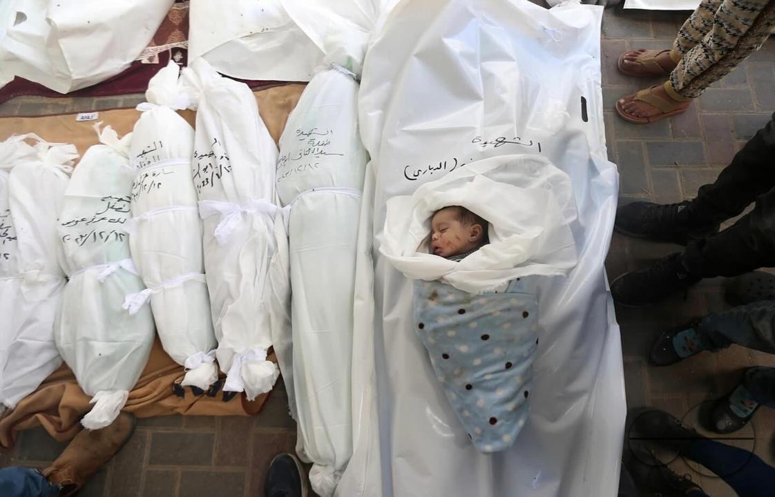Destruction is seen at the site of a home belonging to the Harb family in Rafah, while the familyâs bodies are seen among bodies of other families at the Al-Najjar hospital