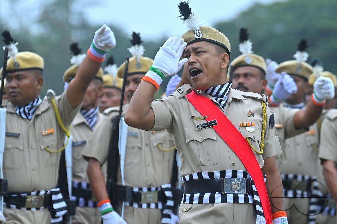 Troopers from the NDRF, Home Guards and Civil Defence take oath on the 61st All India Civil Defence and Home guards raising day at the police parade ground in Agartala