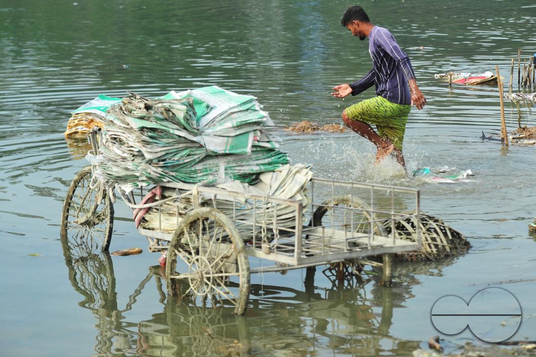 Women are risking their lives to wash cement bags beside the Surma River in Sylhet