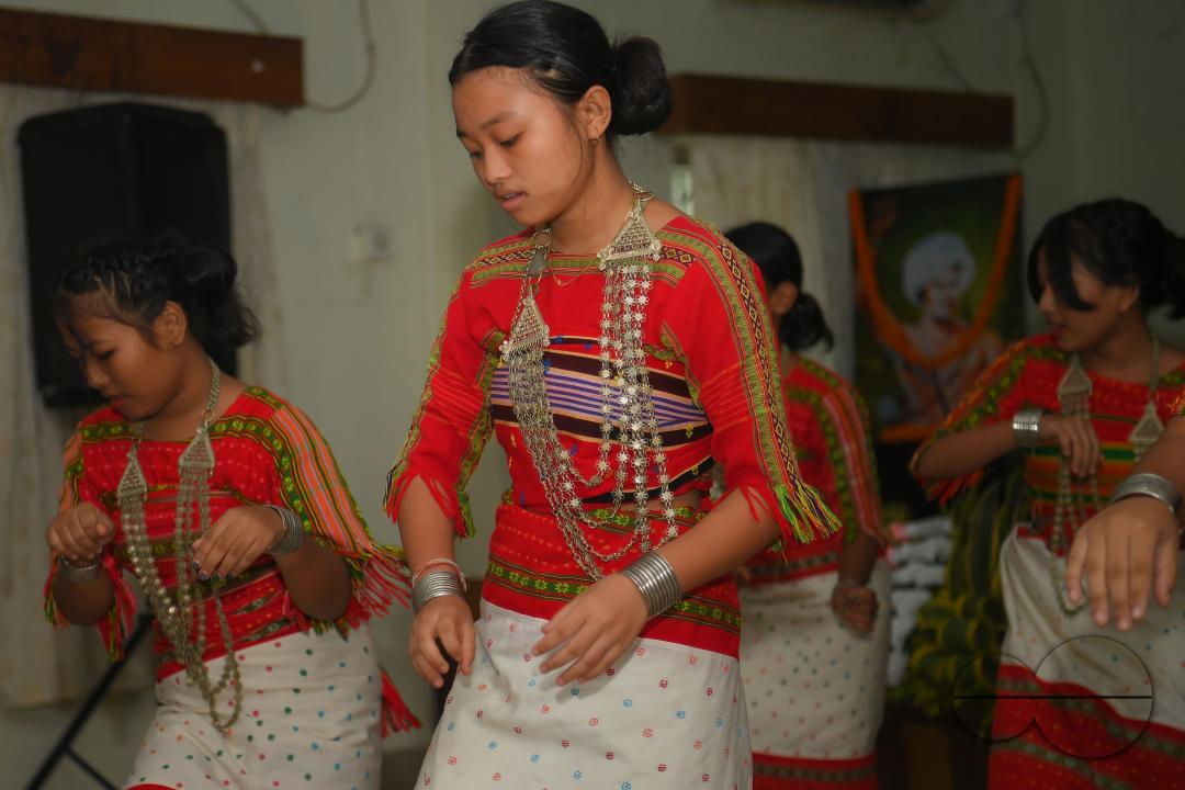 Indigenous girls perform traditional dances on the occasion of World Indigenous Day in an auditorium at Agartala
