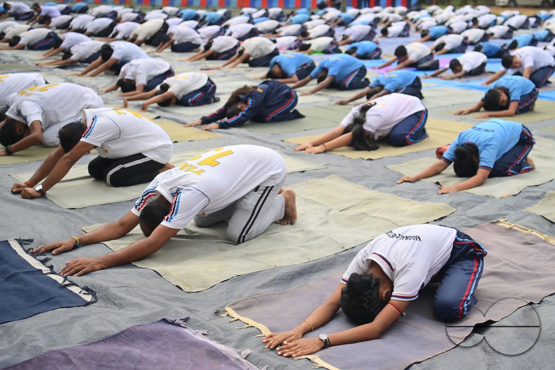 NCC cadets and officials perform yoga during 10th International Day of Yoga Day at BBM College Ground in Agartala