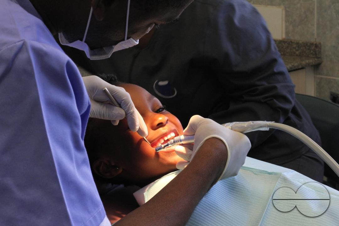 A dentist examines the teeth of a child at a dental clinic in Harare