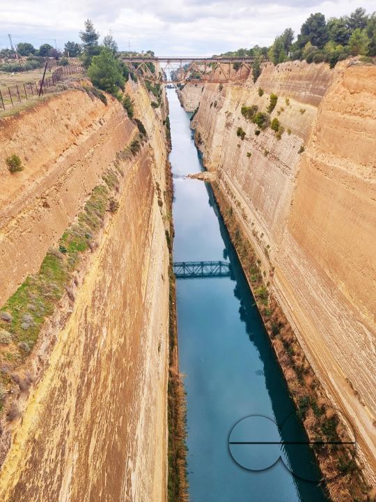 The Corinth Canal is an artificial canal in Greece that connects the Gulf of Corinth in the Ionian Sea with the Saronic Gulf in the Aegean Sea