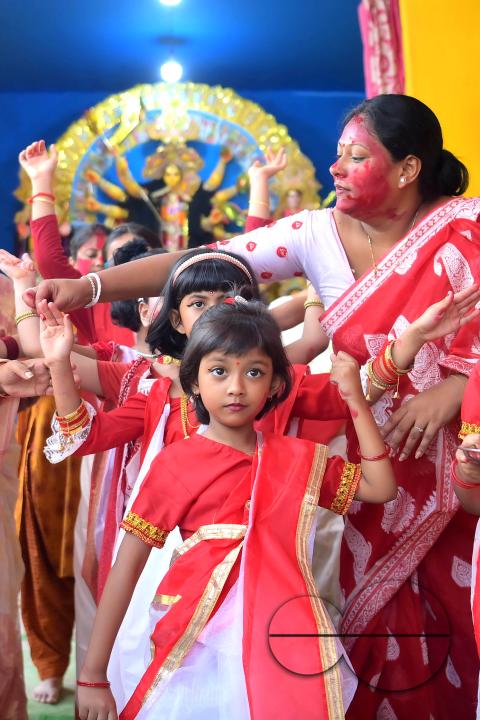 Children and married women are dancing, and the women smear each other with vermillion during a ritual called the vermillion game, or "Sindur Khela," on the last day of the Durga Puja festival in Agartala, Tripura, India.
