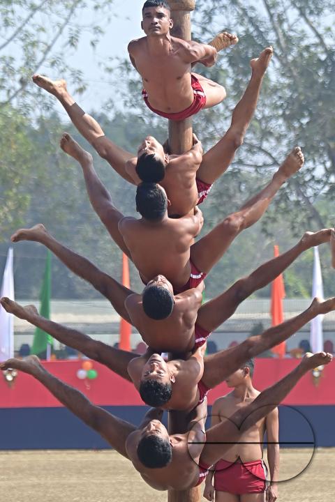 Police officials perform Mallakhamb, a traditional sport, in celebration of 150 years of Tripura Police Week at the stadium of A.D